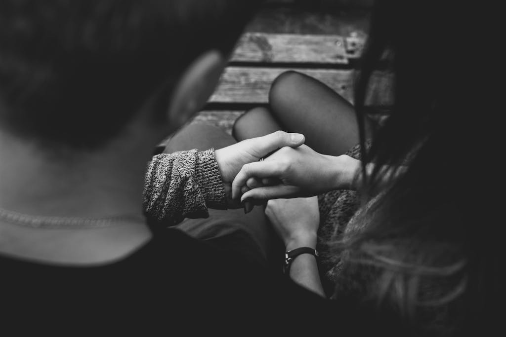 A romantic black and white image of a couple holding hands, symbolizing love and connection. sex positivity