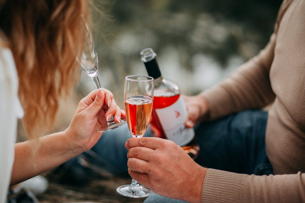 Couple enjoying a romantic outdoor picnic with rose wine, celebrating togetherness. third date tips