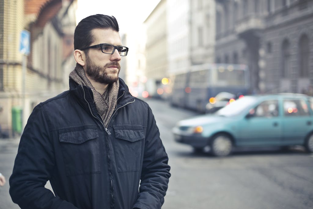 Fashionable man with glasses standing on a bustling street in Budapest, Hungary. first date advice